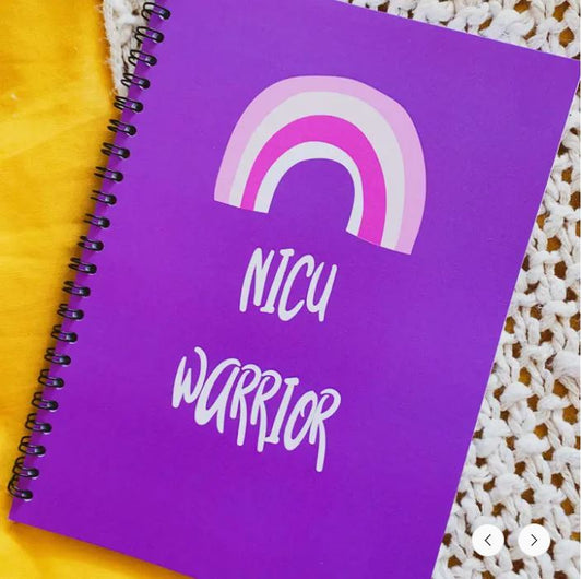 Purple notebook with a rainbow and NICU Warrior text